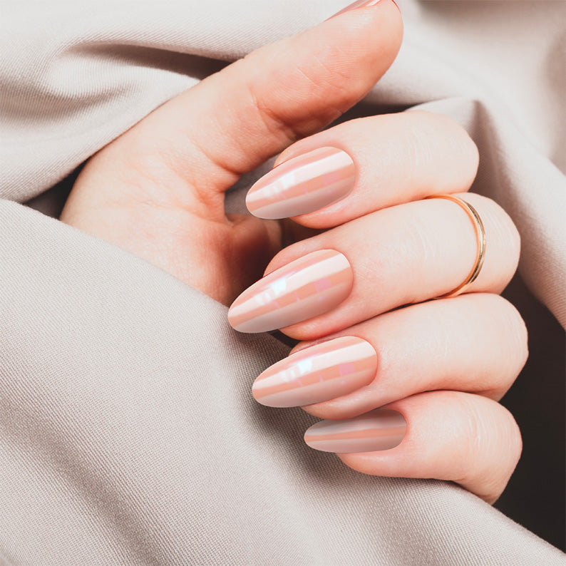 IVY BEAUTY by KISS hand model wearing French glazed press on nails almond nude gloss with thin pearl stripes