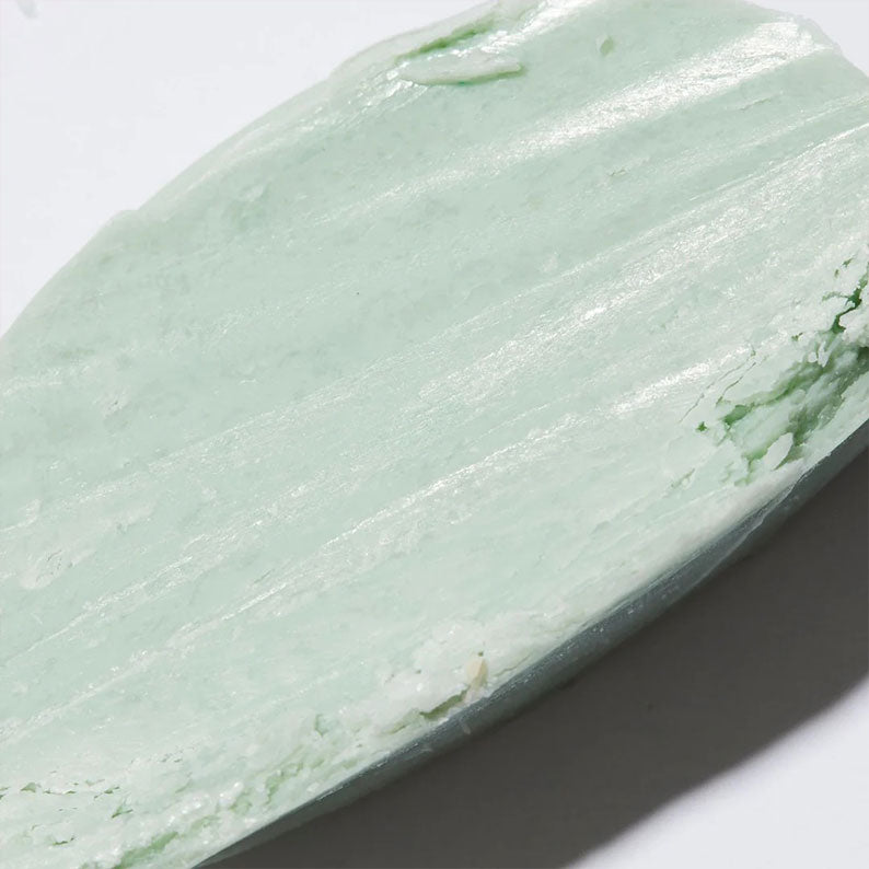 AMBI complexion cleansing bar close up showing pale mint green creamy texture for gentle cleansing