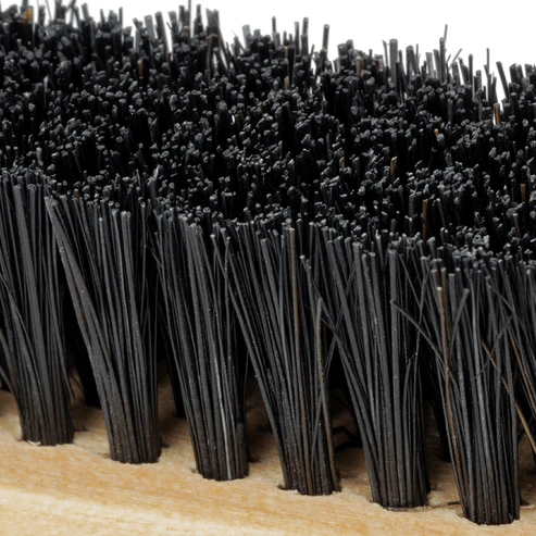 Close-up of black bristles on an Annie edge brush for baby hairs with wooden base