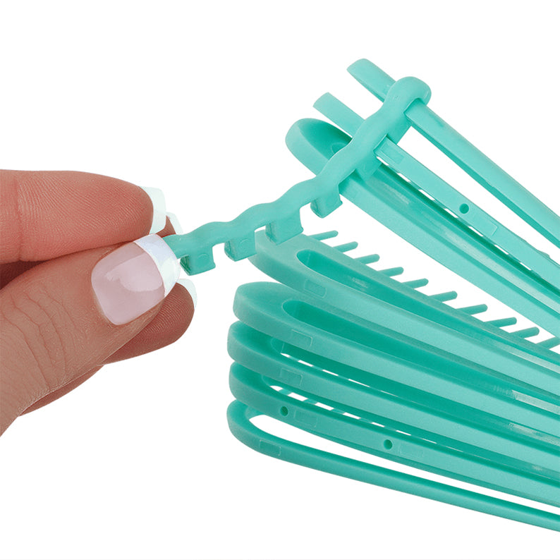 ANNIE vented detangling brush teal with flexible vented teeth and hand holding the brush