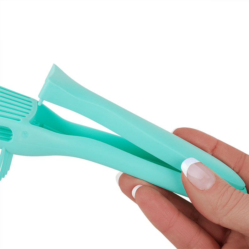 ANNIE mint vented detangling brush with foldable handle held in hand for travel and styling