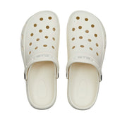 Top view of white air clog shoes with ventilation holes adjustable heel strap textured footbed