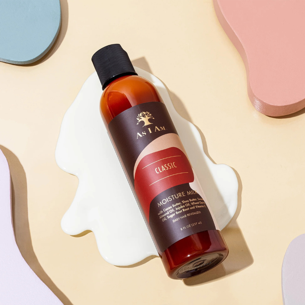 As I Am Moisture Milk leave-in conditioner in a 8 oz bottle on a pastel background for hydration and soft curls