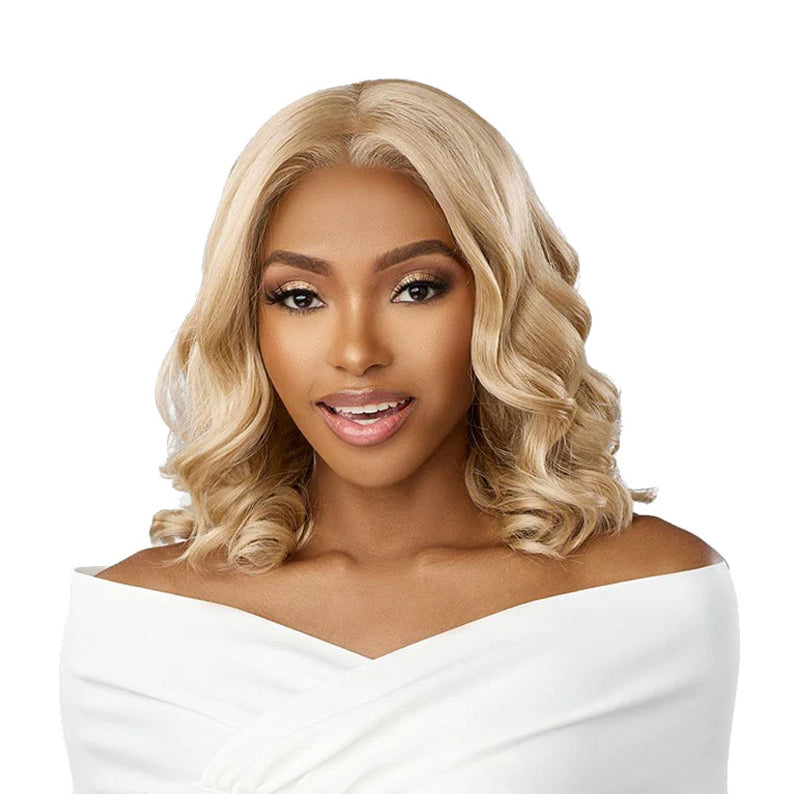 SENSATIONNEL bare lace glueless front wig in honey blonde with shoulder length soft waves and center part on model