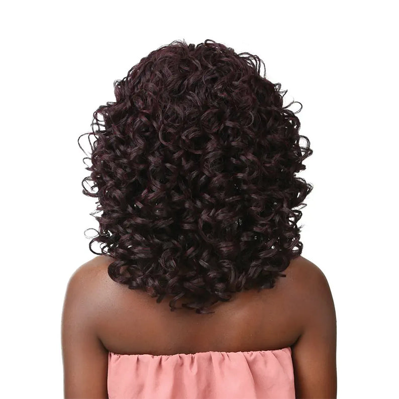 SENSATIONNEL instant fashion synthetic wig deep burgundy tight curls shoulder length back view on model