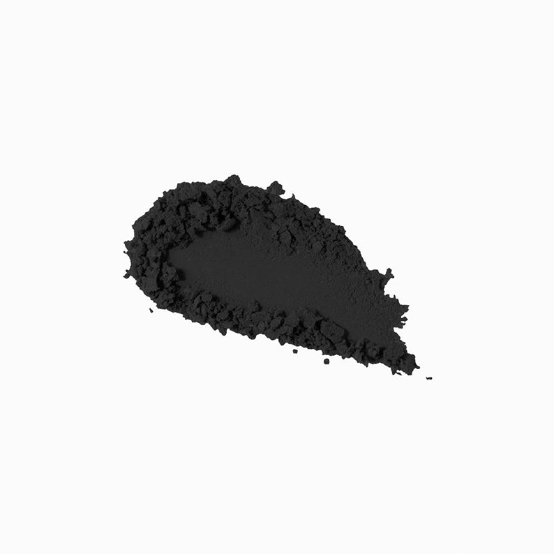 NICKA K black hair concealer powder swatch on white background for covering roots and grays