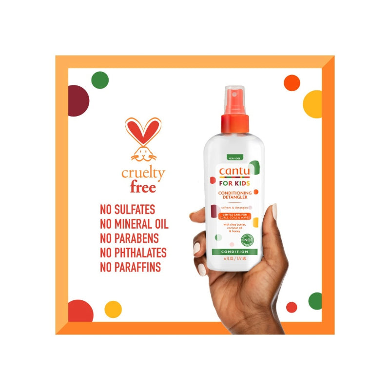 Cantu kids hair detangler spray bottle held in hand with cruelty free and no harmful chemicals listed