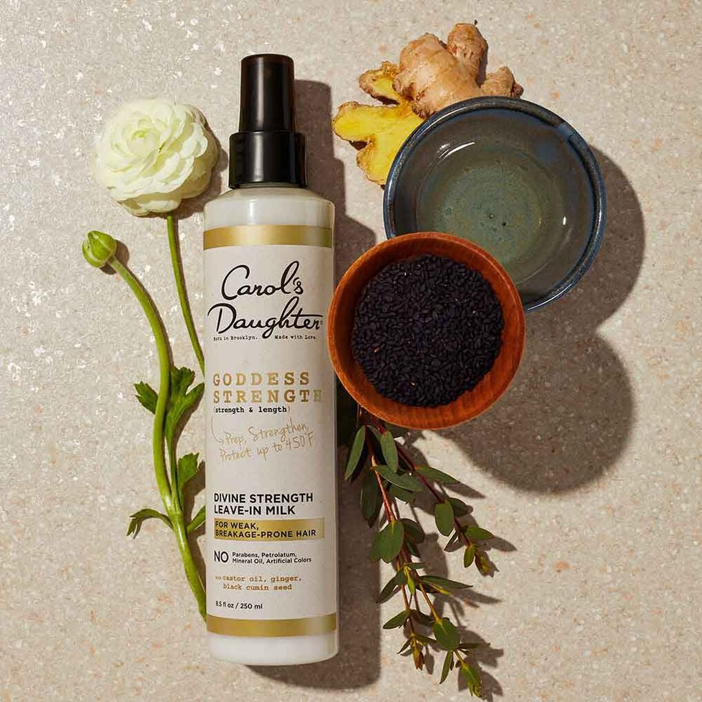 Carols Daughter Goddess Strength Divine Strength leave-in milk for natural hair bottle with ginger flower and seed bowl