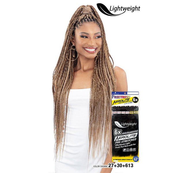 Woman wearing long light brown braids styled high with Freetress Aerolite Braid 52 inch by Shake N Go pack