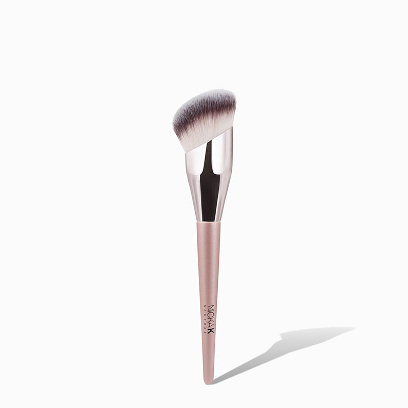 NICKA K angled foundation brush with dense synthetic bristles and rose gold handle
