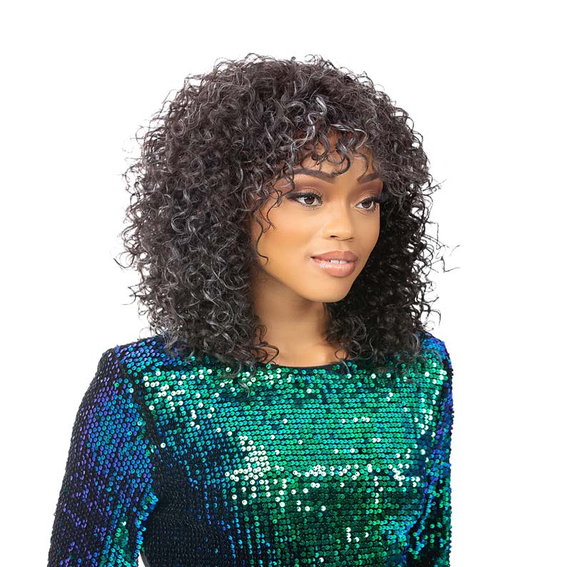 Nutique synthetic full cap wig on model with shoulder length dark curly hair and soft fringe