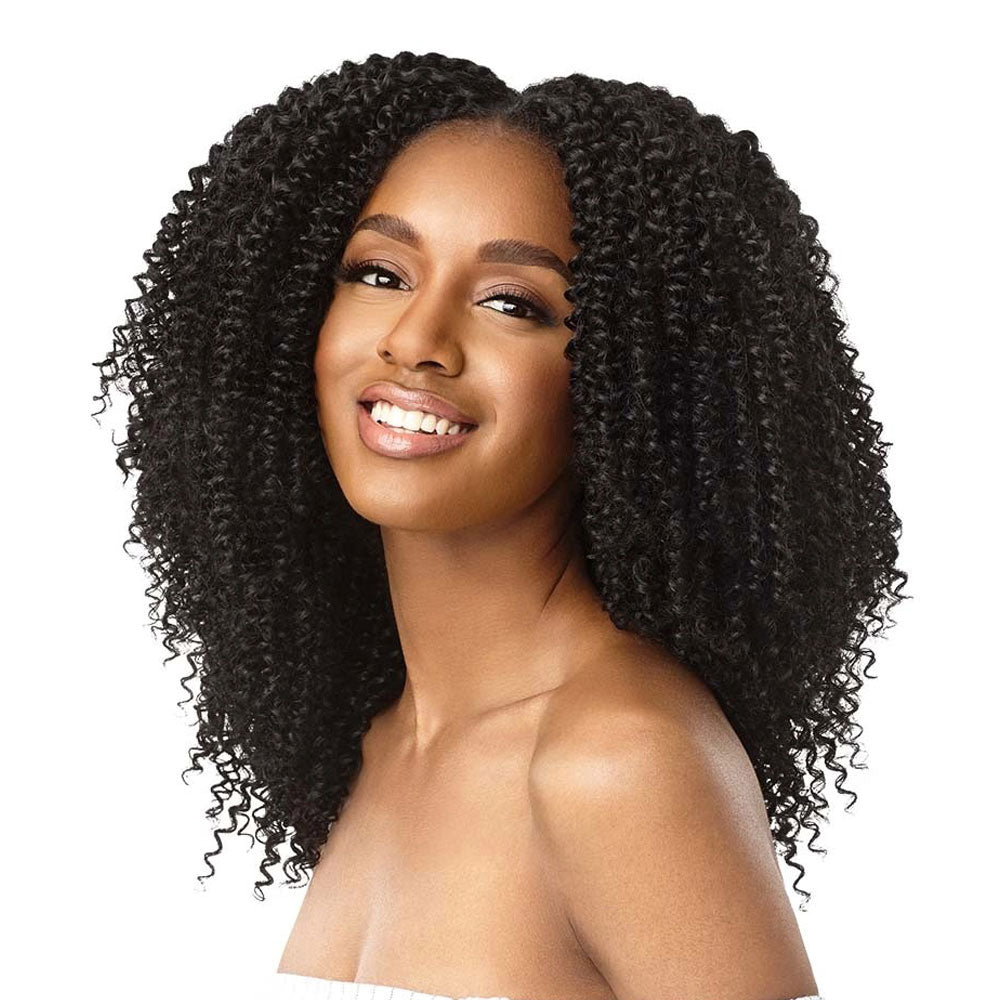 Smiling model wearing OUTRE 4A kinky curly clip in hair extensions in natural black with voluminous tight curls