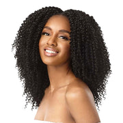 Smiling model wearing OUTRE 4A kinky curly clip in hair extensions in natural black with voluminous tight curls