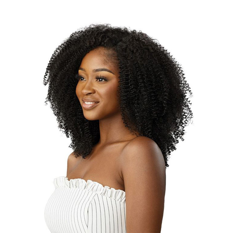 OUTRE afro clip in hair extensions on model with voluminous natural black kinky curly hair