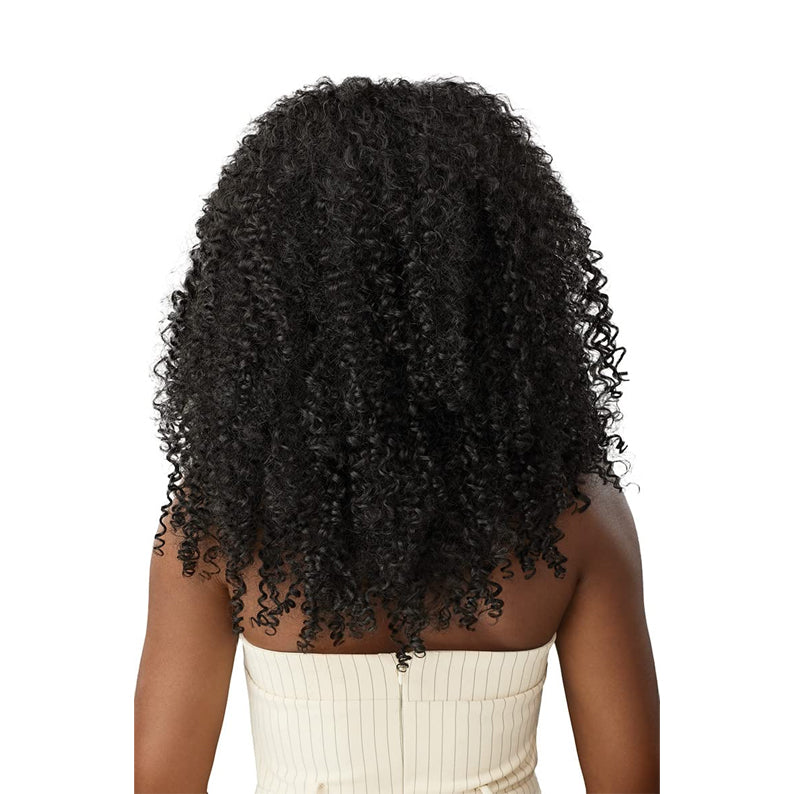 Back view of model wearing OUTRE bohemian curl clip in hair extensions in natural black voluminous shoulder length
