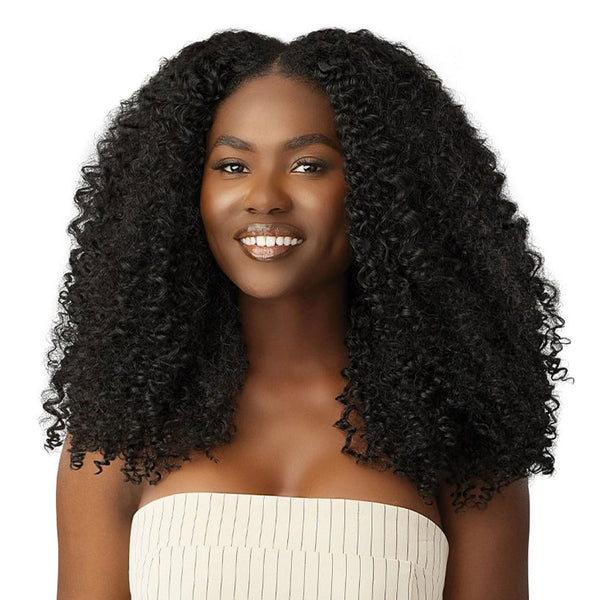 OUTRE bohemian curl clip in hair extensions shown on model with voluminous natural black kinky curly hair