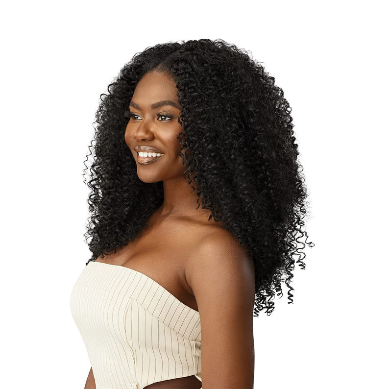 Model wearing OUTRE bohemian curl clip in hair extensions in deep black for voluminous natural curly look