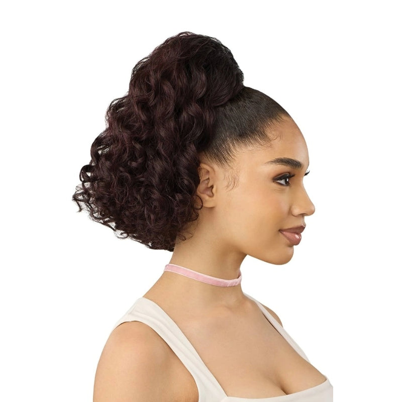 OUTRE curly ponytail hair extension in deep burgundy on model with sleek high pony and defined curls