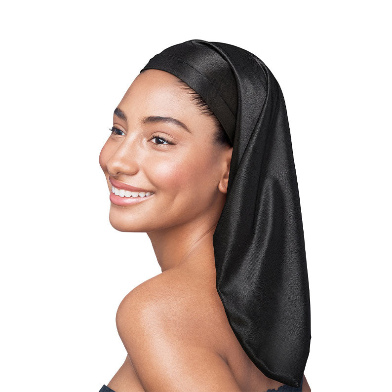 Smiling woman wearing a long black silky braid bonnet for braids to protect and preserve braids overnight