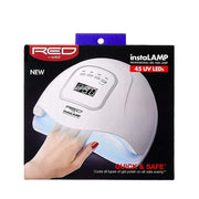 RED BEAUTY by KISS white instaLAMP LED nail dryer showing hand inside UV gel nail lamp for home use.