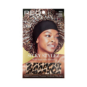 Product packaging showing model wearing RED BEAUTY by KISS extra large silky bonnet leopard print with wide black edge