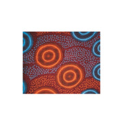 African print scarf for women with vibrant orange and teal concentric circle pattern on brown fabric