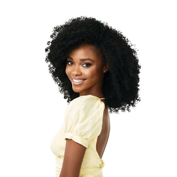OUTRE synthetic curly half wig in natural black on smiling model with voluminous defined coils for easy styling
