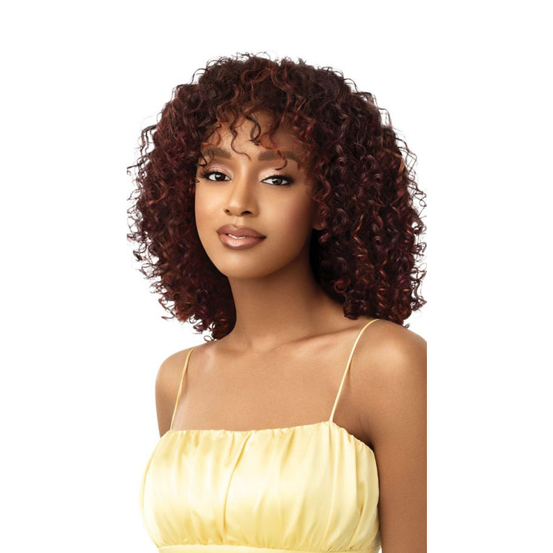 OUTRE synthetic half wig beach waves in auburn curly shoulder length with soft bangs on model