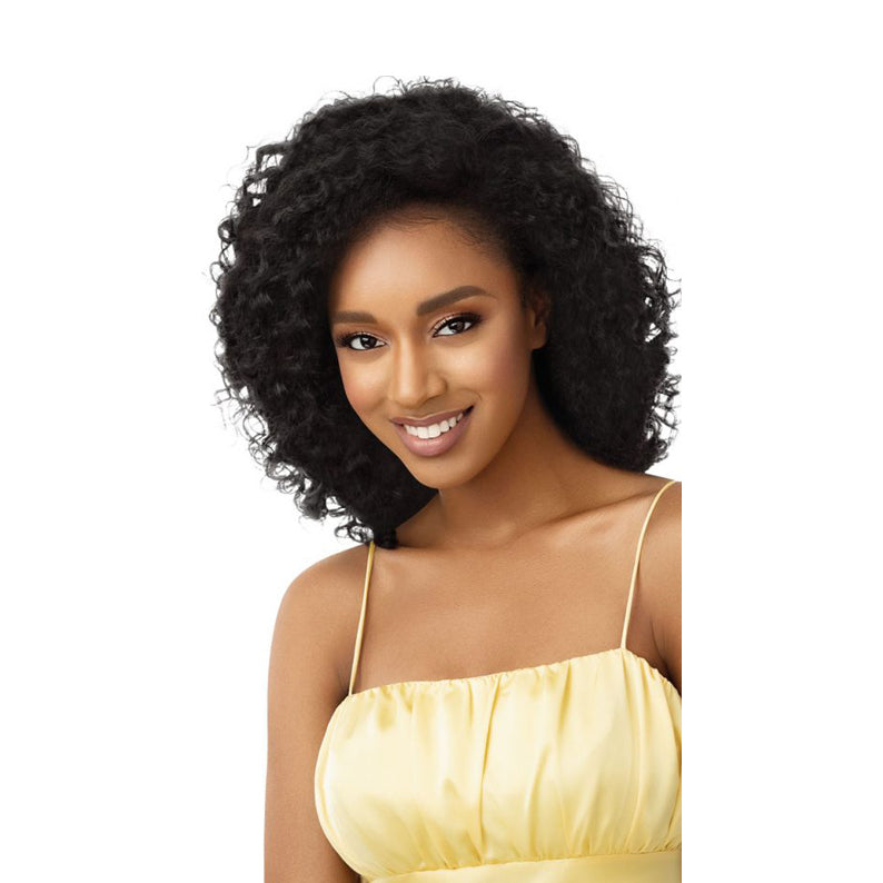 OUTRE synthetic half wig beach waves in natural black with voluminous curly texture on smiling model
