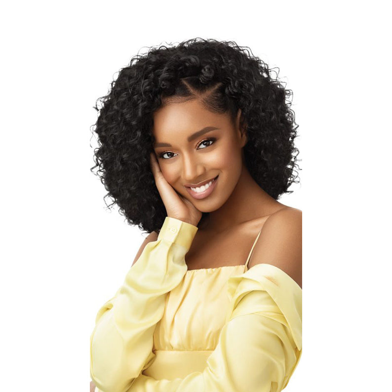 OUTRE synthetic half wig beach waves in natural black on model with shoulder length voluminous curls