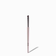 NICKA K angled eyebrow brush for makeup with slim rose gold handle and angled bristles for precision