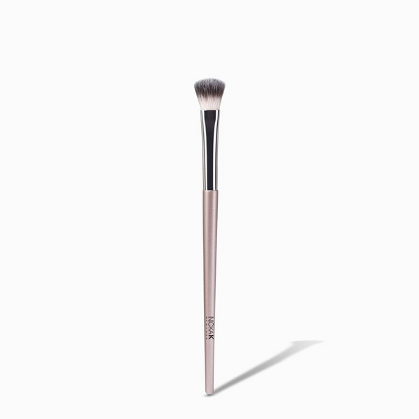 NICKA K powder eyeshadow brush with soft synthetic bristles and pink handle on white background