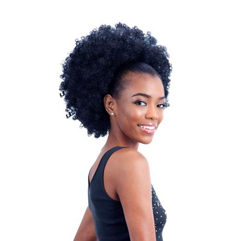 Smiling woman wearing SHAKE N GO Freetress Equal drawstring ponytail curly afro extension in black