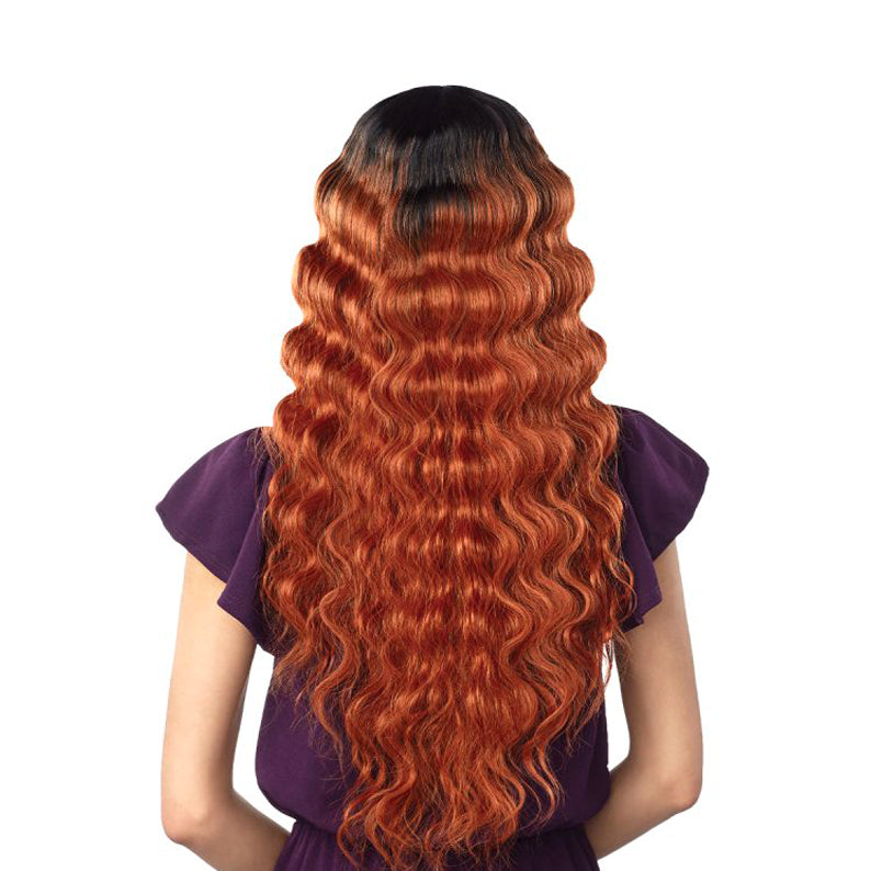 SENSATIONNEL synthetic long wavy wig with bangs copper ombre and dark roots shown from back on model