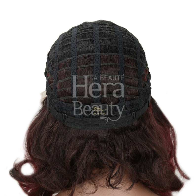 OUTRE synthetic lace front wig back view showing open weft cap adjustable straps and burgundy wavy hair