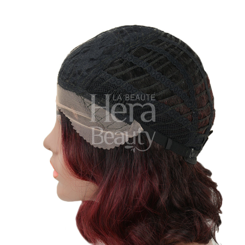 OUTRE synthetic lace front wig on mannequin showing black adjustable cap and burgundy wavy hair