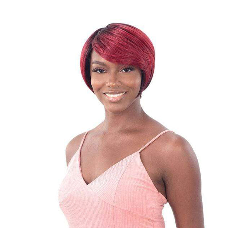 SHAKE N GO Freetress Equal synthetic wig short red bob with side swept bangs on smiling model in pink top