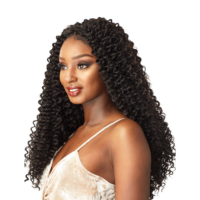SENSATIONNEL Island Twist crochet braids on woman with long curly black hair and beige top