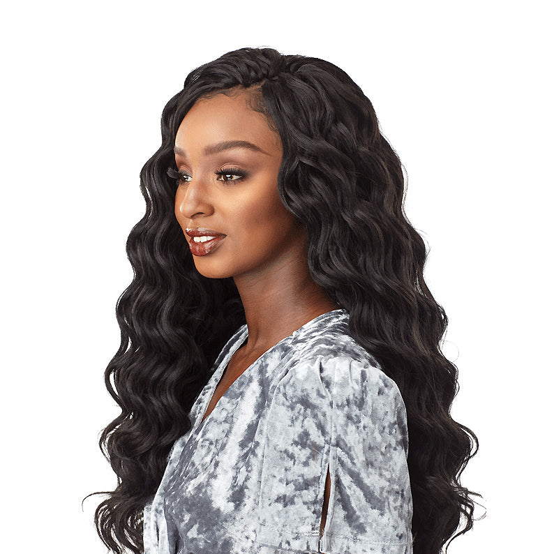 Sensationnel ocean wave crochet braids in long black wavy style on woman with silver top