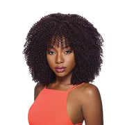 OUTRE curly afro braid hairstyle in dark brown worn by woman in orange top
