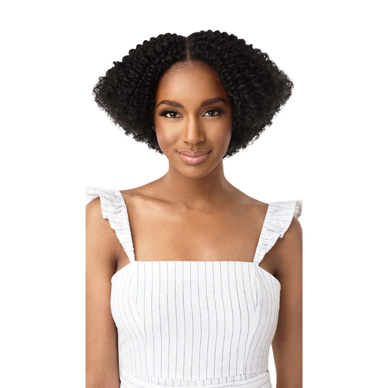 Model wearing OUTRE 4A kinky curly clip in hair extensions. Short natural black afro curls with center part