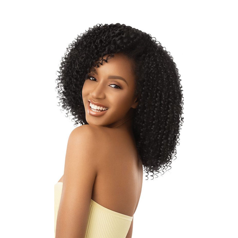 OUTRE after midnight synthetic half wig on a smiling woman with natural black curly shoulder length hair