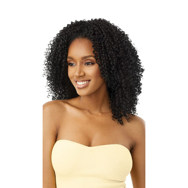 OUTRE after midnight synthetic half wig in natural black tight curls on smiling model