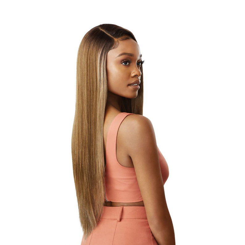 OUTRE model wearing a blonde synthetic lace front wig 28 inch sleek long straight style with side part