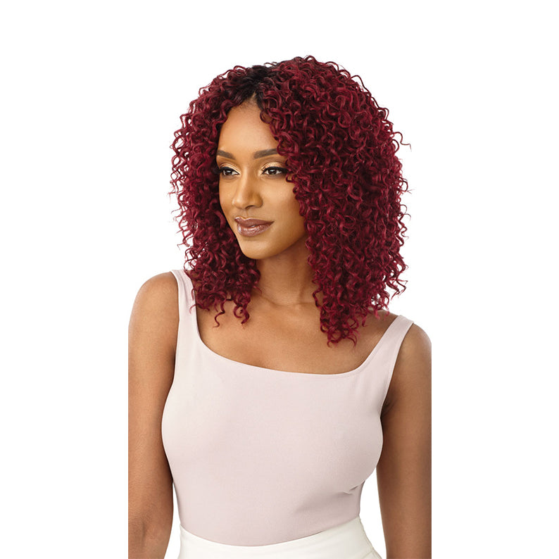 OUTRE wet and wavy boho curl wig in burgundy shoulder length on model with natural center part