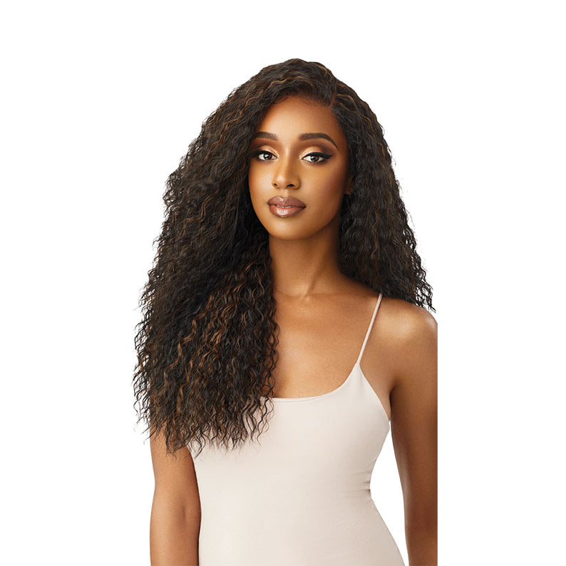 OUTRE 13x6 lace frontal wig long deep curly brown with honey highlights on model wearing nude tank